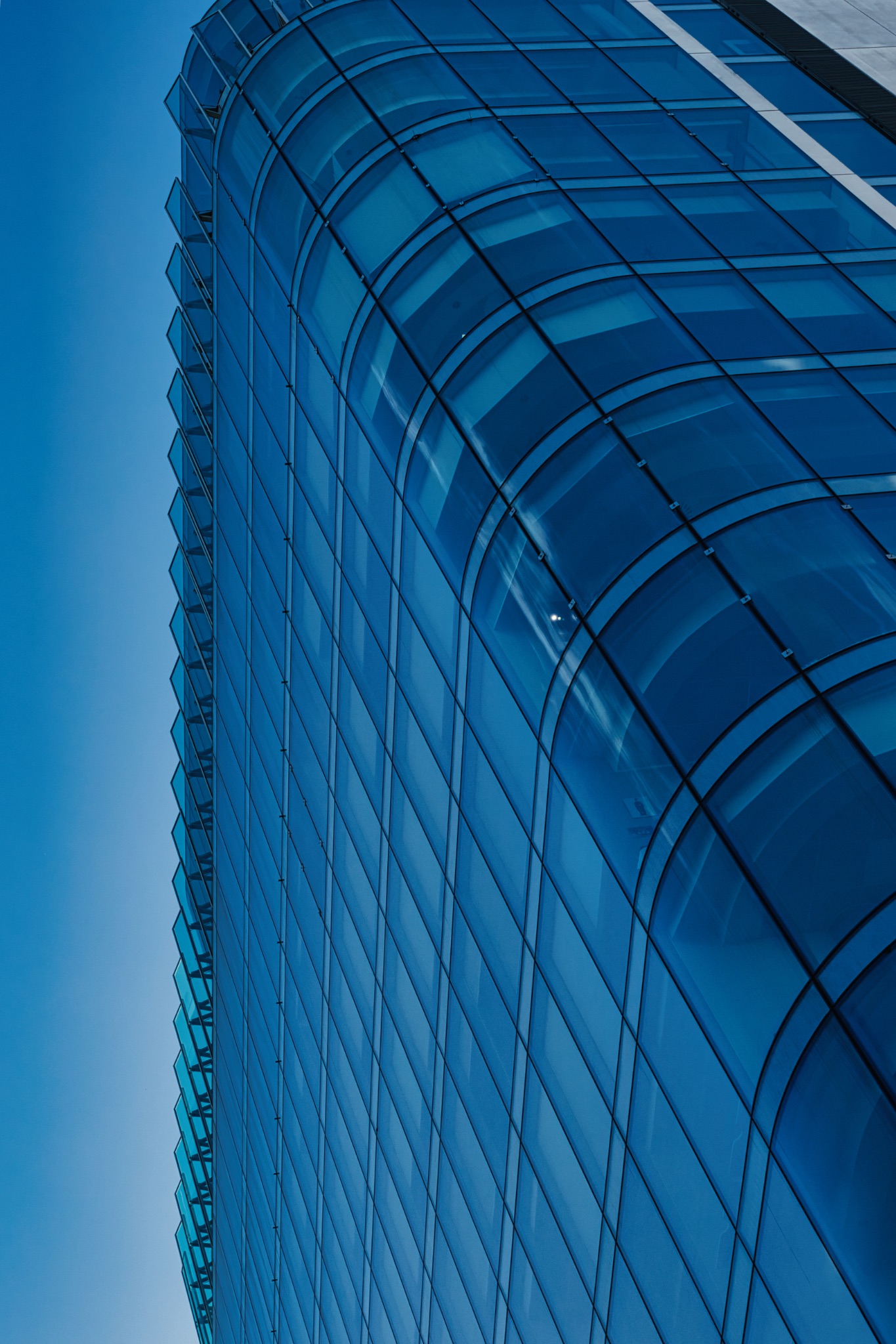 Low-Angle View of a Modern Glass Building in Manchester, UK.